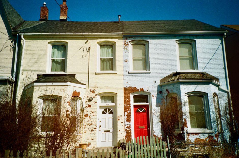 Brick houses with white trim and painted red and white doors.